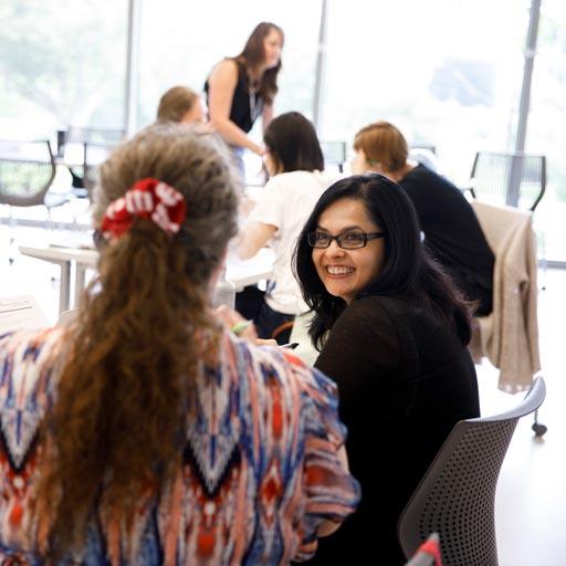 Several faculty members interact at a workshop. 